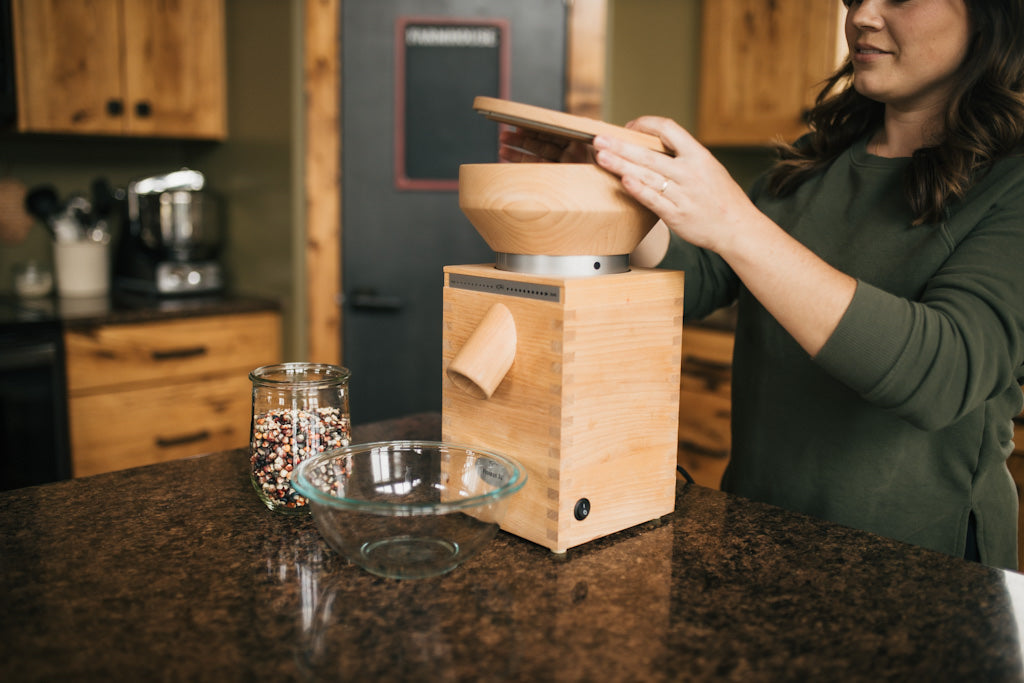 Owner of Living Sky Farms using a Komo Mill to mill whole grains from Canada