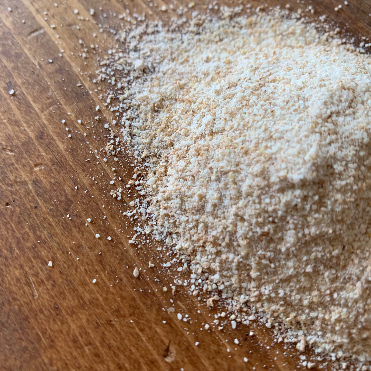 Living Sky Farms Hard Red Wheat Flour on a brown table.