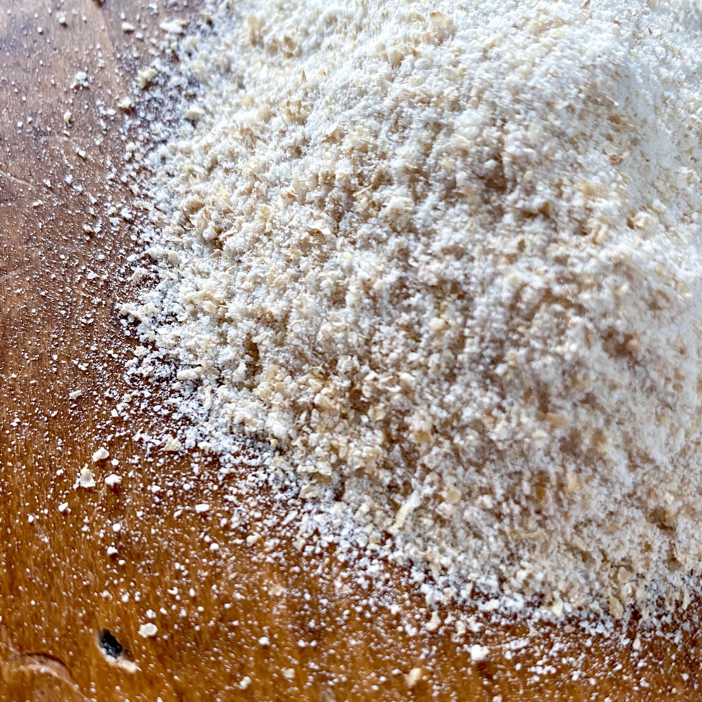 Living Sky Farm's Hard White Wheat Flour on a brown table.