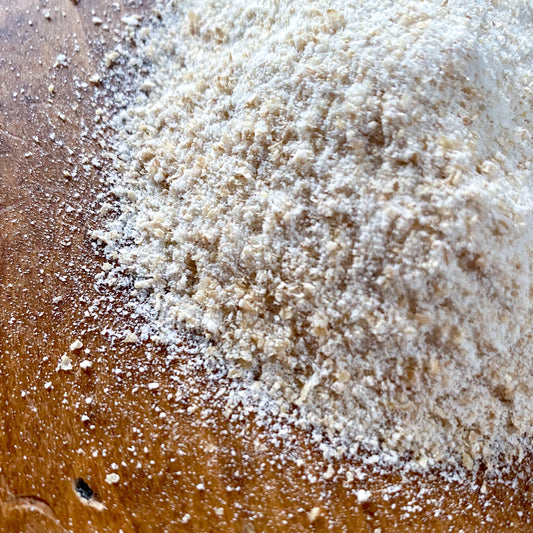 Living Sky Farm's Hard White Wheat Flour on a brown table.