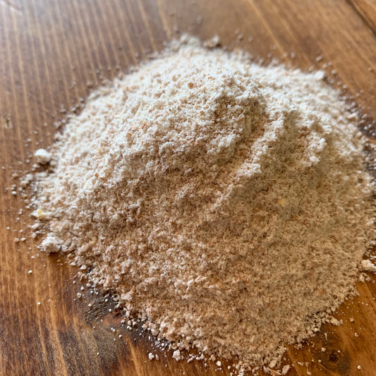 Living Sky Farm's Spelt Flour on brown table.